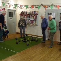 The end of a competitive match. Players evaluating the bowls near the end of a match.