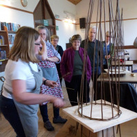 The hall is used for a variety of craft classes. A demonstration of wicker weaving at a class in the village hall.