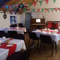 Getting ready for Christmas Tables inside the hall decorated for Christmas.
